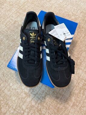 adidas men’s Black Suede Sneakers with White Stripes and Gold Accents